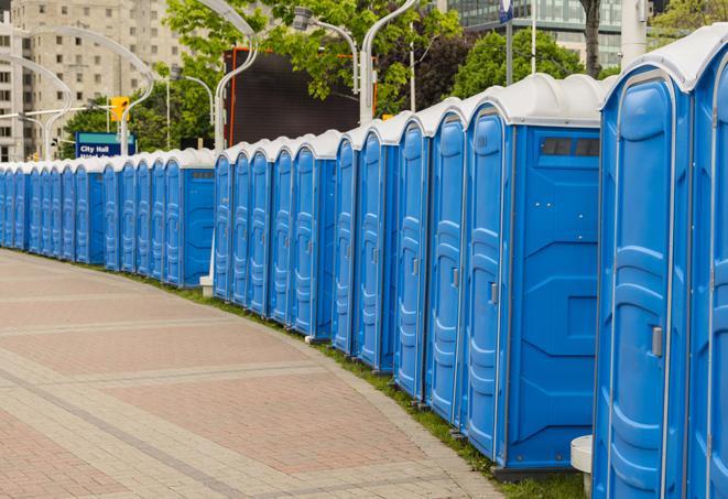 a line of portable restrooms at a sporting event, providing athletes and spectators with clean and accessible facilities in Anna